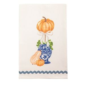 White cotton towel with blue chinoiserie vase, orange pumpkin topiary, and rick rack trim