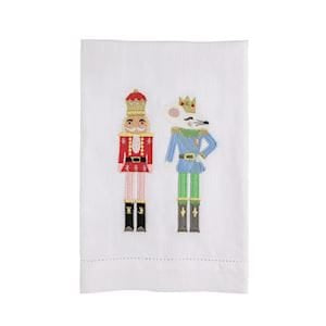White embroidered hand towel featuring two colorful holiday nutcracker figures