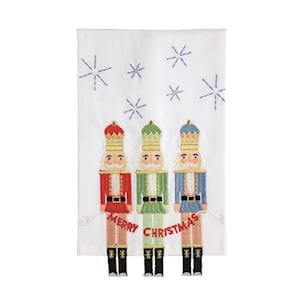 White holiday kitchen towel with three colorful nutcracker figures and Merry Christmas banner