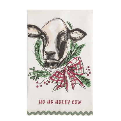 White kitchen towel with black and white cow, Christmas wreath, and Ho Ho Holly Cow text