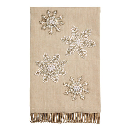 Beige linen hand towel with beaded white and gold snowflake embellishments and fringe trim