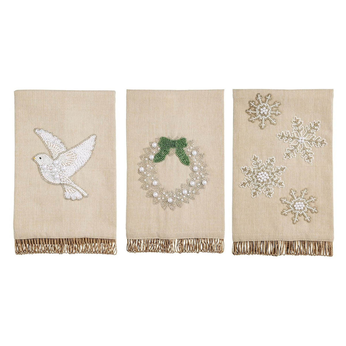 Three beige linen Christmas hand towels with beaded dove, wreath, and snowflake designs, gold fringe trim
