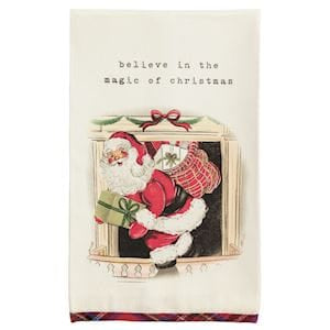 Cream kitchen towel with Santa at fireplace and 'believe in the magic of christmas' text