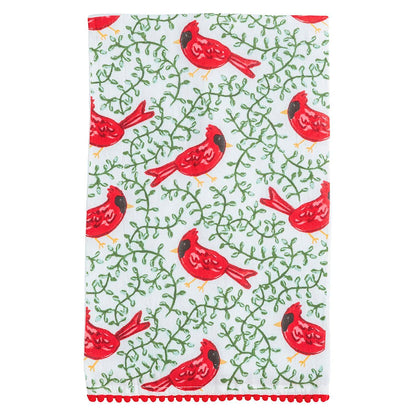 White kitchen towel with red cardinal birds, green vine pattern, red pom-pom trim