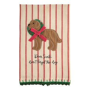 A Christmas-themed kitchen towel with red and cream vertical stripes, featuring an embroidered brown dog wearing a green wreath and pink bow, with the text 'Dear Santa, don't forget the dog' and a green patterned border.