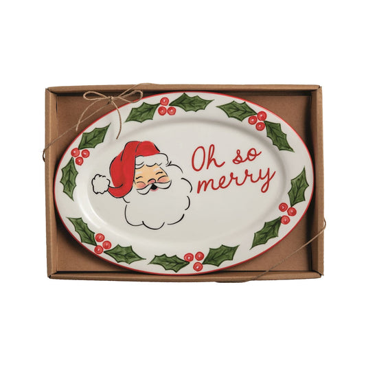 White oval ceramic plate with Santa face, holly border, and Oh So Merry text in gift box