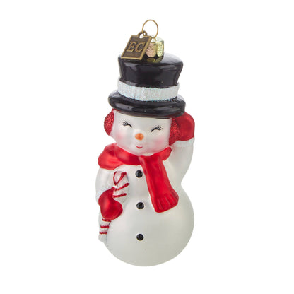 Glass snowman ornament with black top hat, red scarf, earmuffs, and candy cane, front view