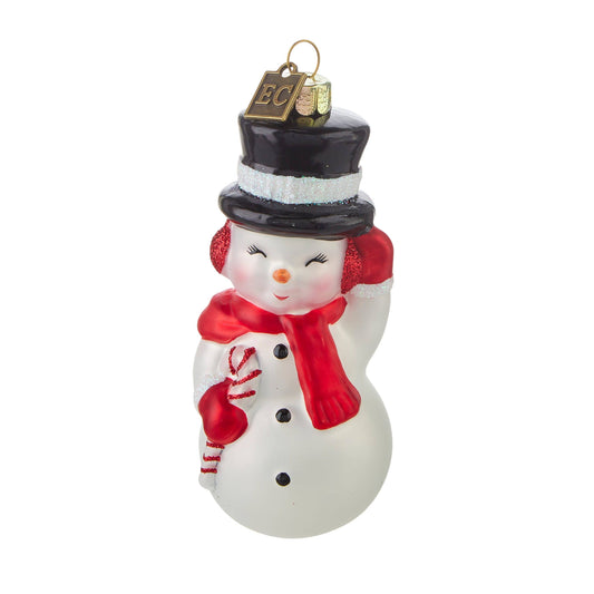 Glass snowman ornament with black top hat, red scarf, earmuffs, and candy cane, front view