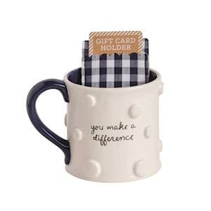 Cream ceramic mug with blue handle and polka dots holding a gingham gift card sleeve