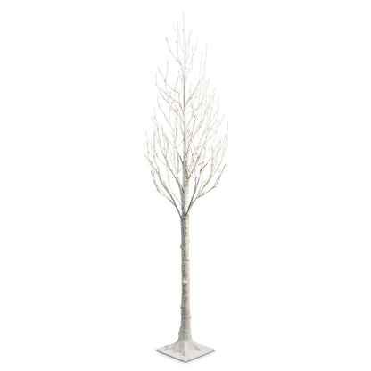 Tall snow-flocked bare branch tree with warm white lights on a square base, front view