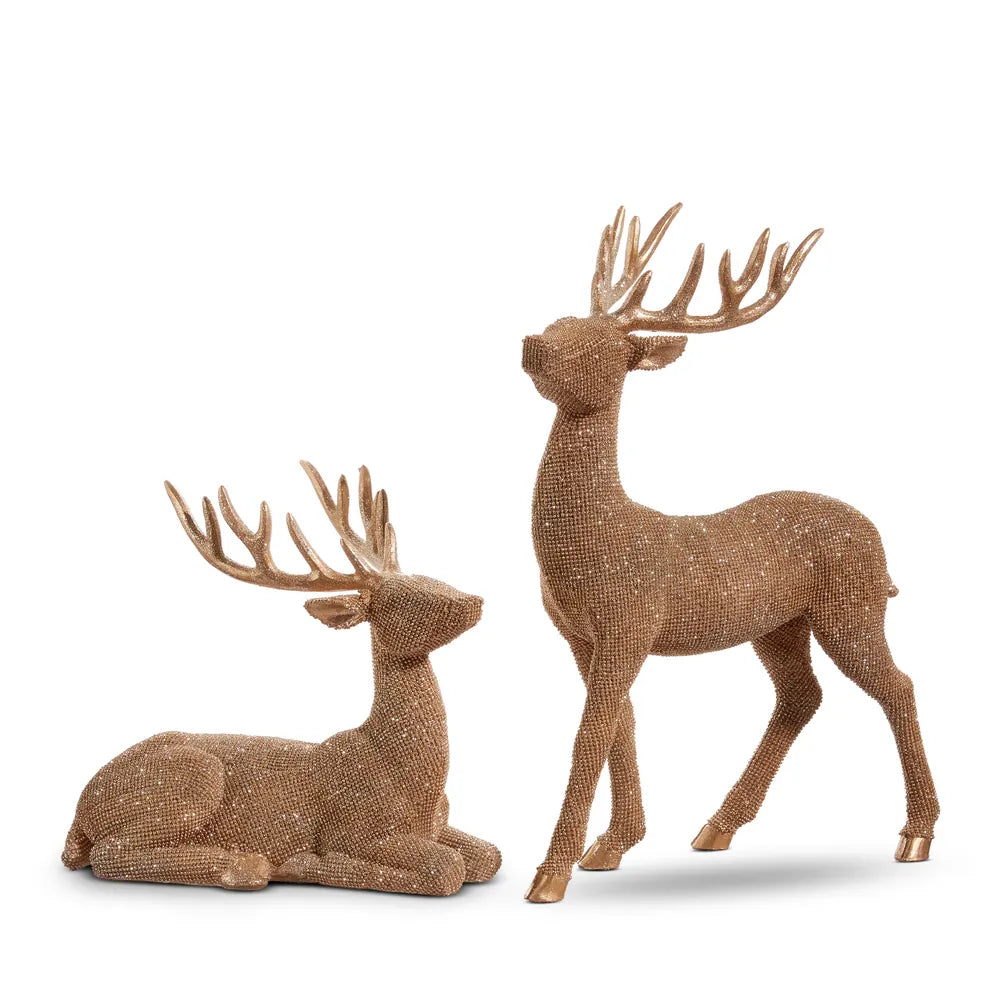 Bronze glittered resin deer figurines, one standing and one lying down, with antlers