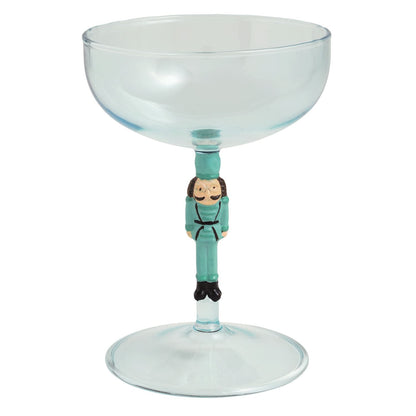 Teal coupe cocktail glass with nutcracker soldier figurine stem by Mudpie