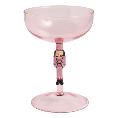 Pink glass coupe with nutcracker soldier stem figurine, Christmas cocktail glass