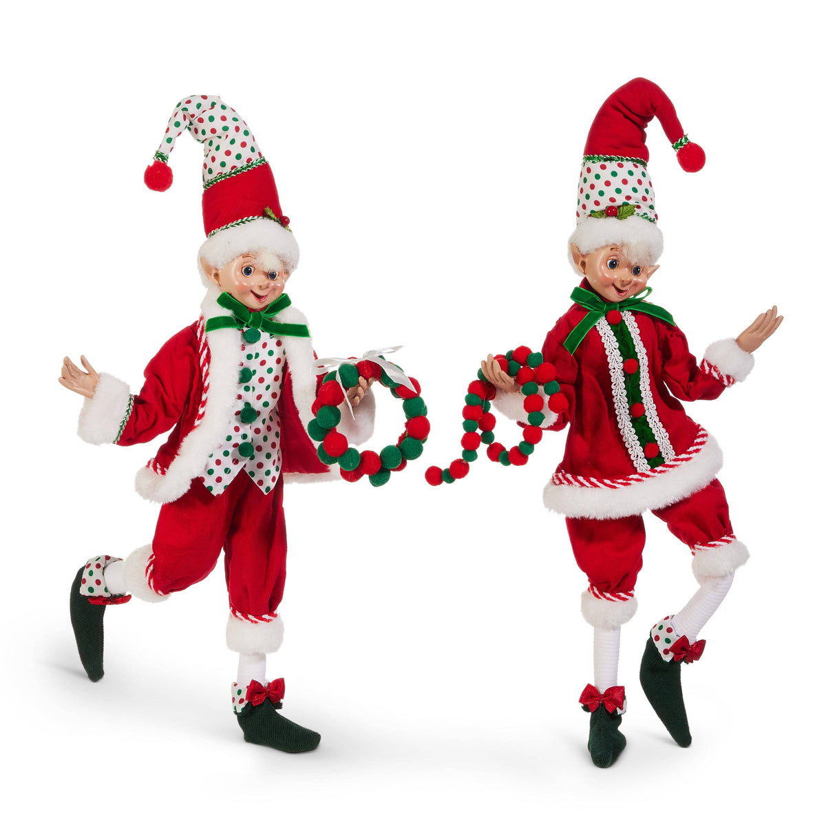 Two posable Christmas elf figurines in red and polka dot outfits holding a pom-pom wreath