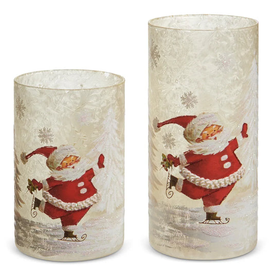 Two frosted glass cylinder containers with vintage skating Santa Claus holiday scene