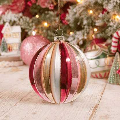 Ribbed glass ball ornament with pink, magenta, gold, and white vertical stripes, hanging display