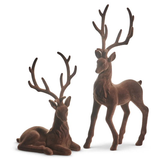 Set of two brown flocked deer figurines, one standing and one laying down