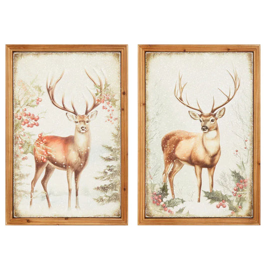 Framed metal wall art depicting stags in snowy winter forest with holly berries, set of 2