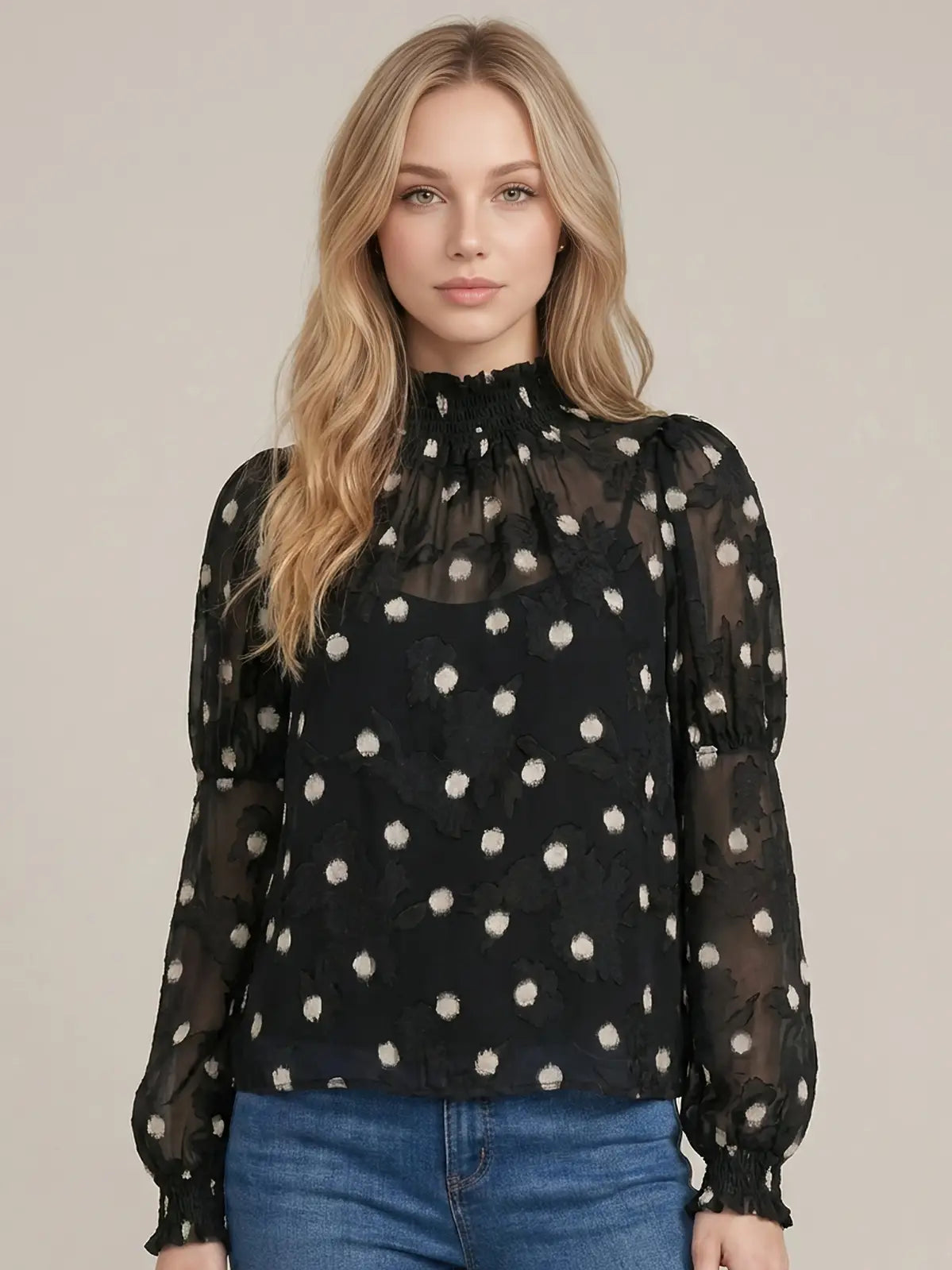 Black sheer mock-neck blouse with white polka dots and smocked cuffs