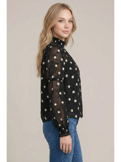 Black sheer polka dot mock neck blouse with puff sleeves and smocked cuffs