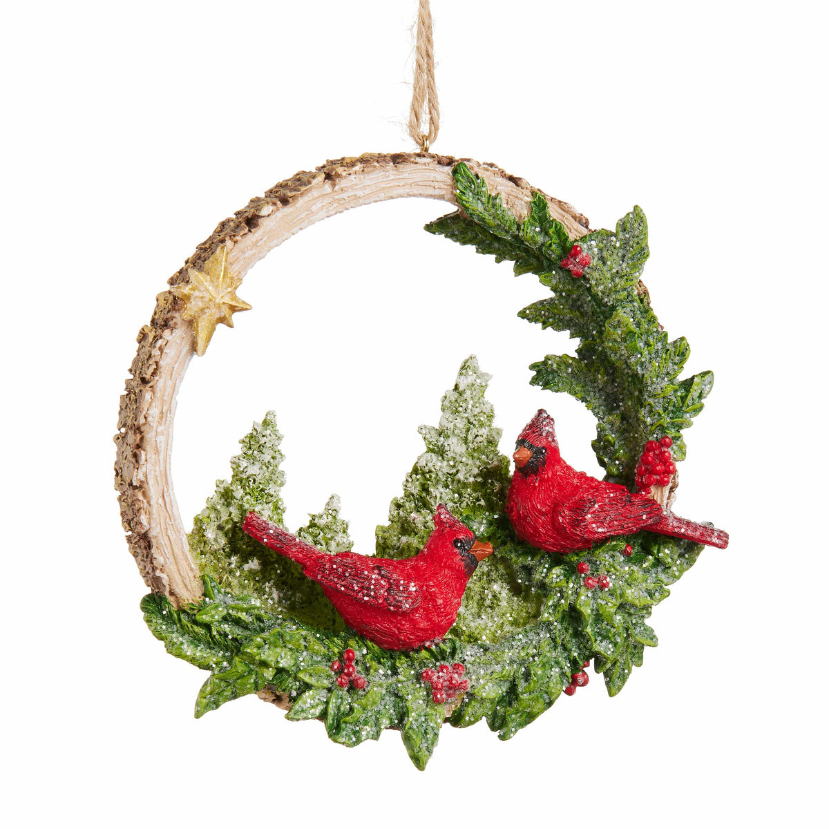 Circular birch wood Christmas ornament with two red cardinal birds among snowy evergreen branches and berries