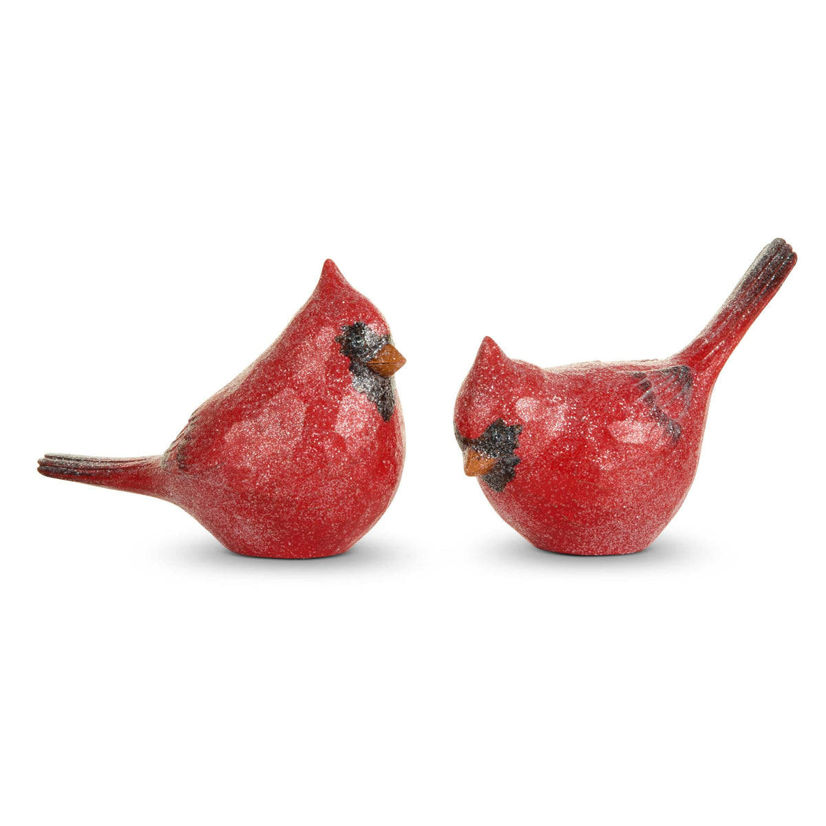 Two red glitter-finished cardinal bird figurines with black facial markings, shown side by side