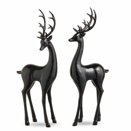 Pair of glossy black deer figurines with antlers standing upright, facing each other
