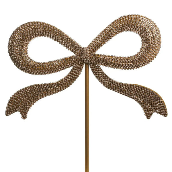 Jeweled bow-shaped Christmas tree topper on a gold stem, covered in rhinestones