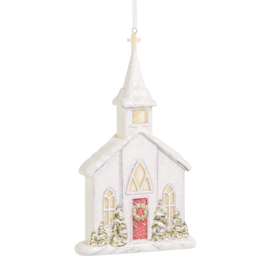 Glittery white church Christmas ornament with steeple, cross, red door, and snowy evergreen trees