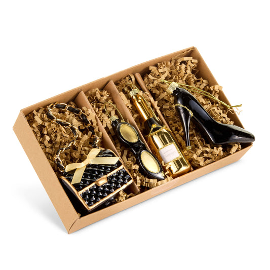 Gift box set of four glamour-themed ornaments including purse, sunglasses, champagne bottle, and high heel