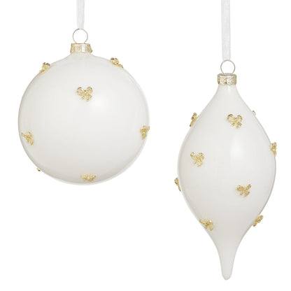 Two white glass Christmas ornaments with gold bow accents, round and teardrop shapes