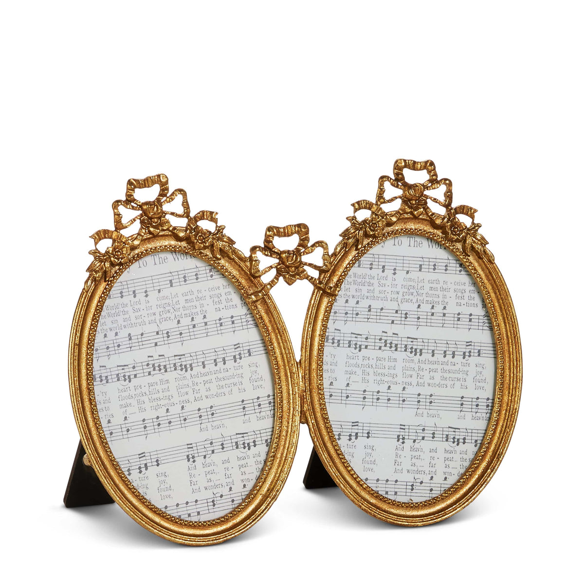 Pair of ornate gold oval picture frames with decorative bow and floral embellishments, displaying sheet music