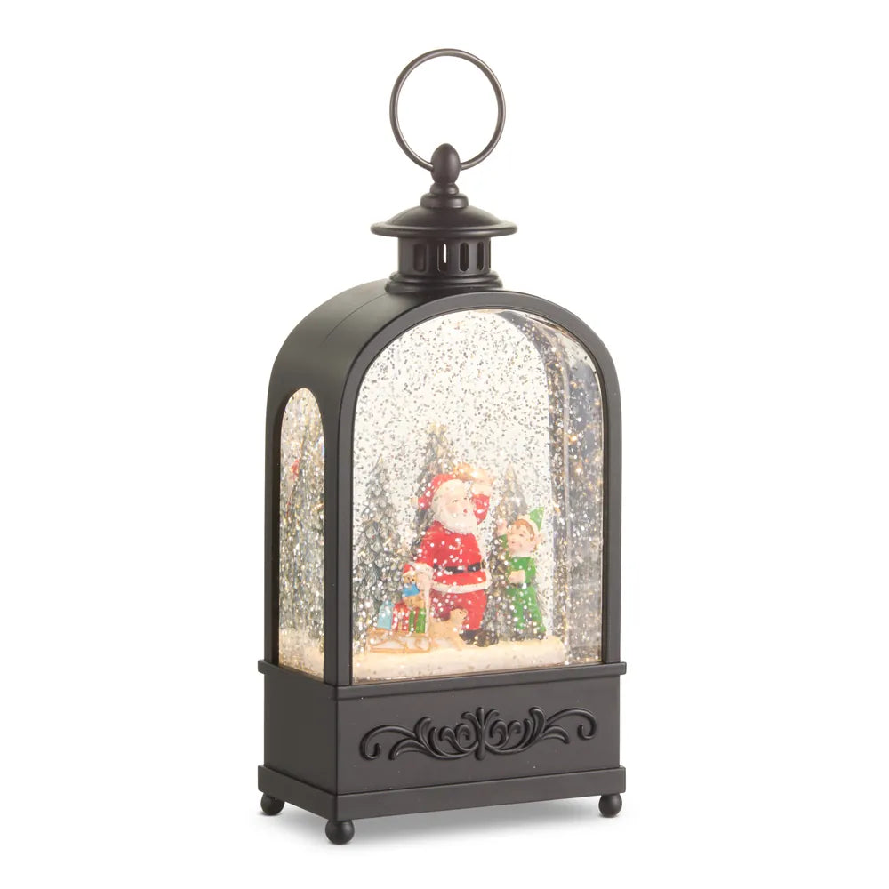 Black lantern-style snow globe with Santa and elf figurines inside, glitter swirling