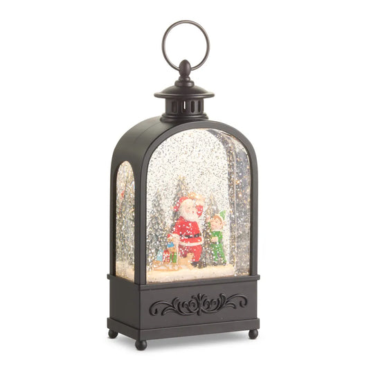 Black lantern-style snow globe with Santa and elf figurines inside, glitter swirling