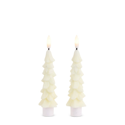 Pair of ivory Christmas tree-shaped taper candles with lit flames, set in white holders