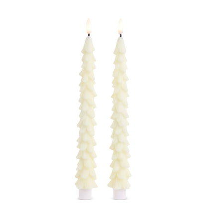 Pair of lit ivory taper candles shaped like textured Christmas trees on white bases