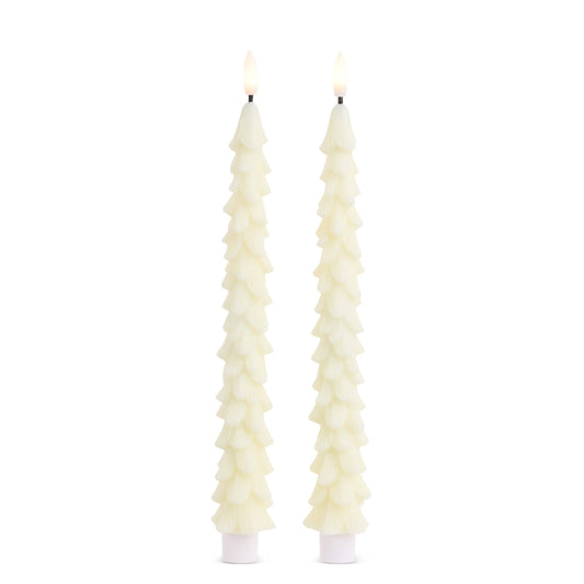 Pair of lit ivory taper candles shaped like textured Christmas trees on white bases