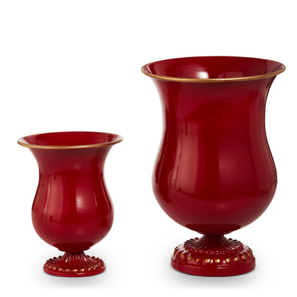 Two red ceramic urn-style vases with gold rim and decorative pedestal base, small and large sizes