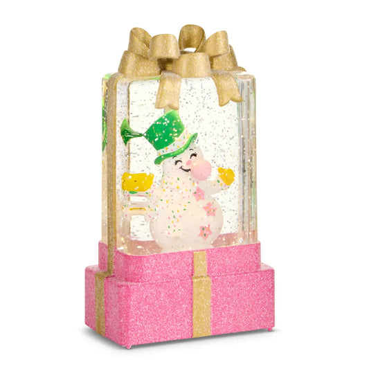 Pink glitter gift box snow globe with white snowman figurine and gold bow top