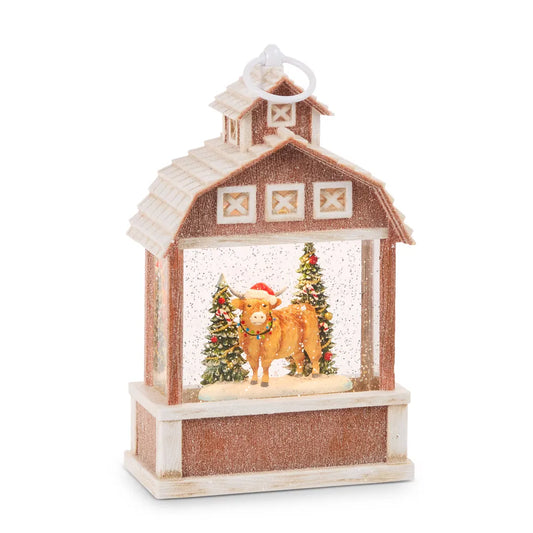 Red barn-shaped water lantern with Highland cow Santa hat glitter snow globe interior