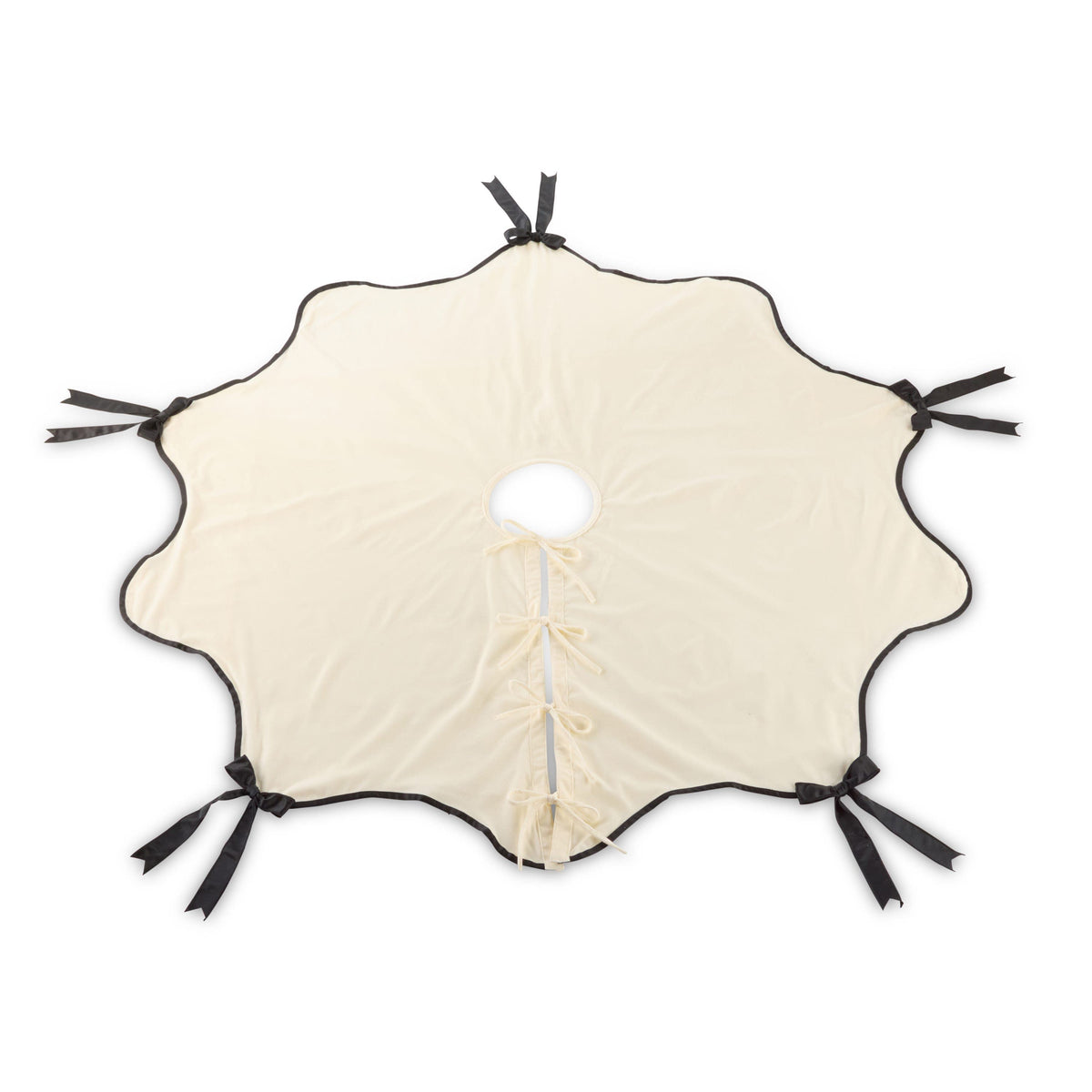 Round scallop-edged tree skirt in cream velvet with black satin ribbon bows and center lace-up closure