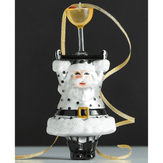 Upside-down Santa ornament in black and white polka dots balancing a champagne coupe glass on top