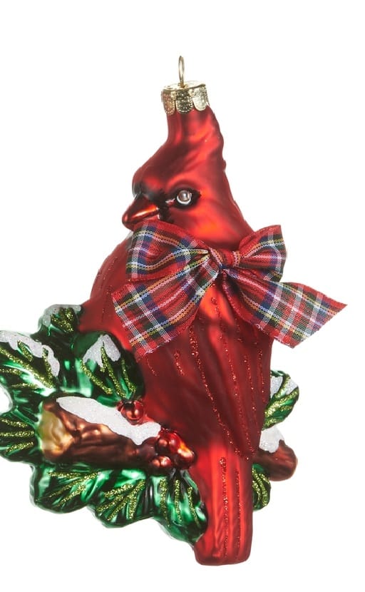 Red cardinal glass ornament with plaid bow perched on holly wreath