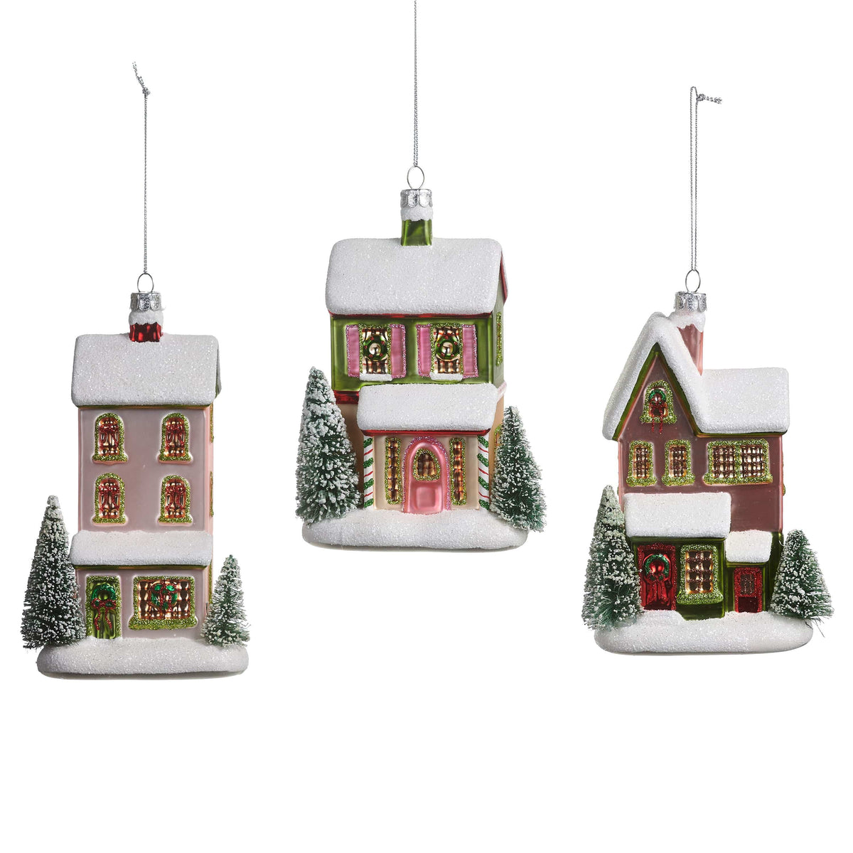 Set of three glass house Christmas ornaments with snow-covered roofs and miniature bottle brush trees