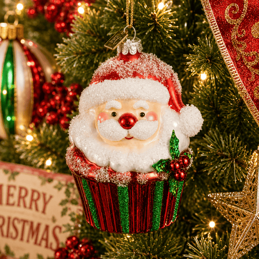 Glass Santa Claus cupcake ornament with glittery red and green wrapper, holly accent, hanging on Christmas tree