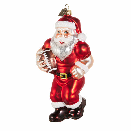 Glass Santa Claus ornament in red suit holding a football, muscular athletic pose