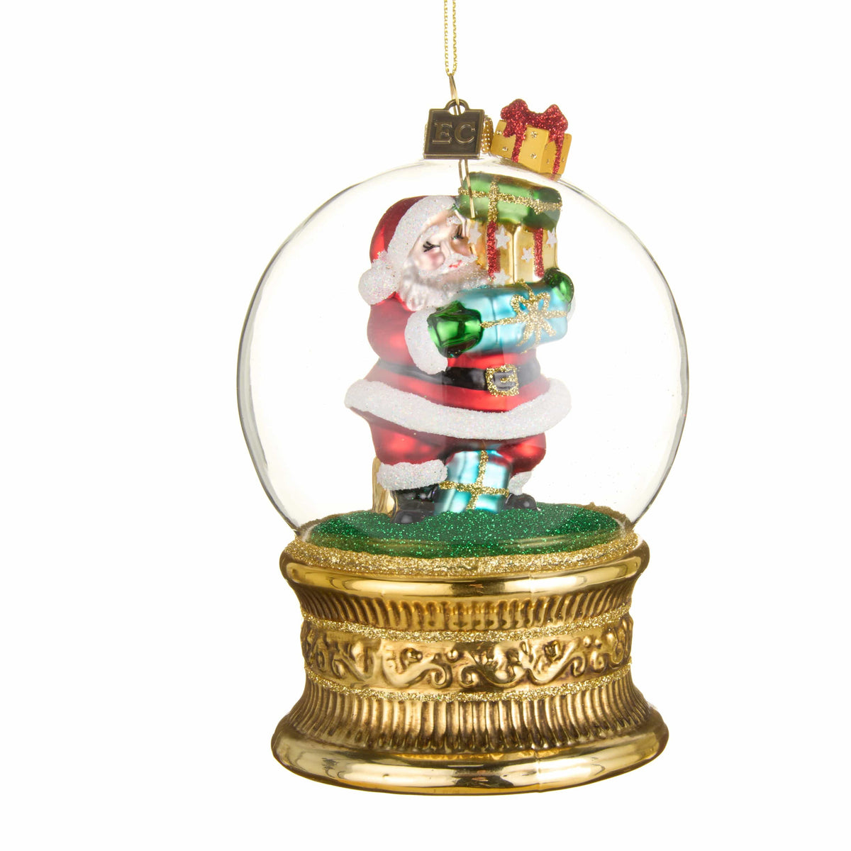 Glass globe ornament with Santa carrying stacked gifts inside, on ornate gold base