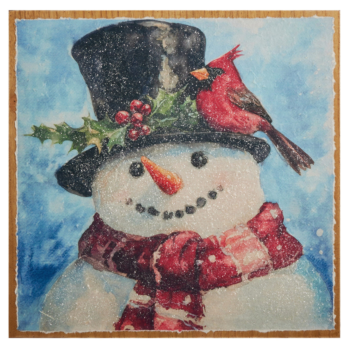 Square wall art on wood panel featuring a smiling snowman with black top hat, red cardinal, and plaid scarf