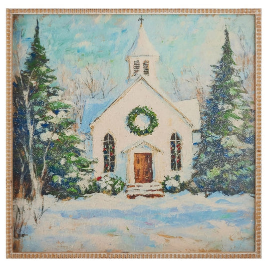 Framed painting of snow-covered white church with Christmas wreath and evergreen trees