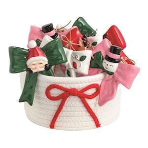 Mudpie ceramic Christmas ornaments with bow motifs in green, pink, and red holiday styles